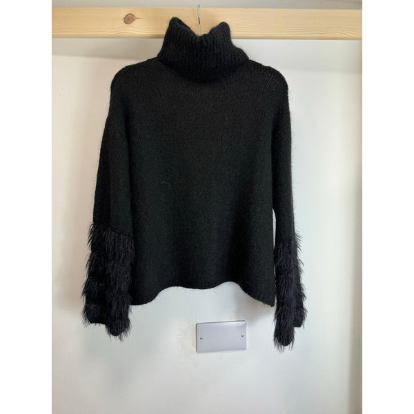 black roll neck with four fluff design on the cuffs 