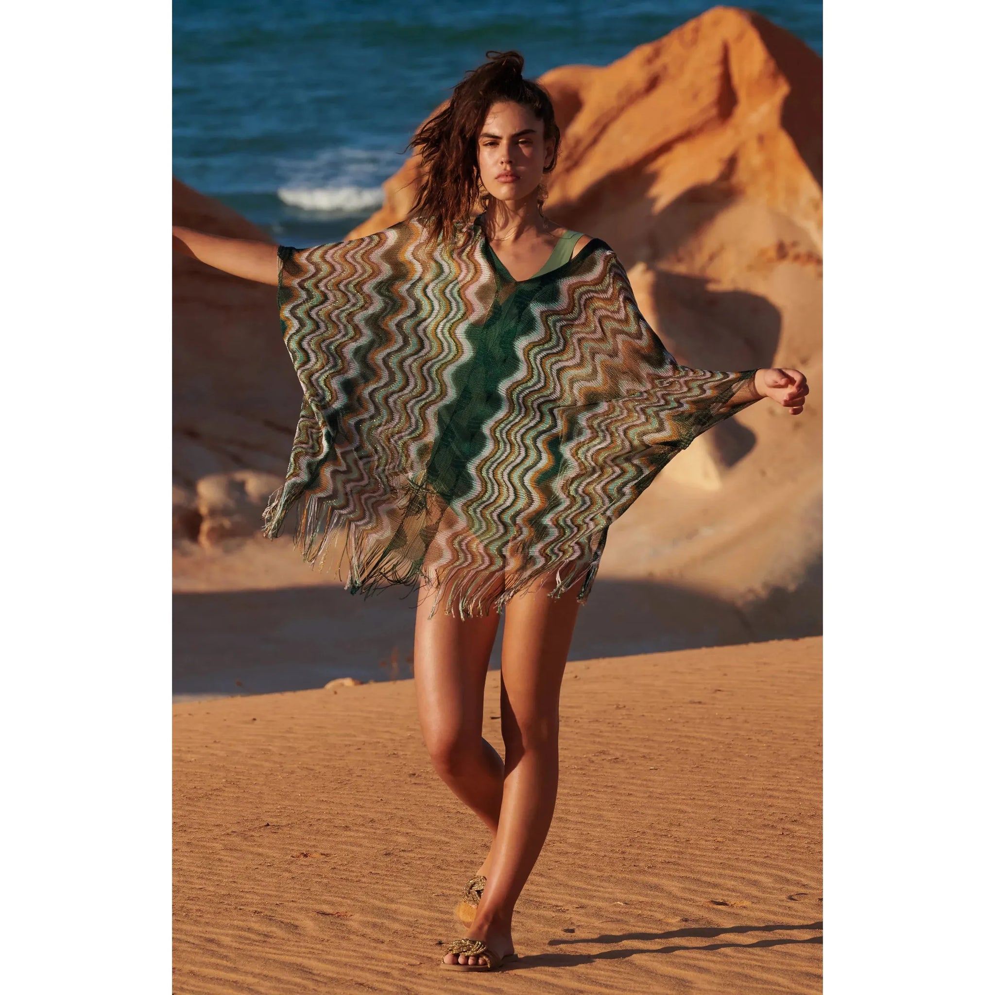 Semi-transparent poncho in thin multi-coloured zig-zag fishnet Fringed at the bottom Front and back V-necklines
