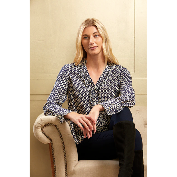 curved shirt style hem and small side slits. With a soft frill to the front and neck this detail is copied through to the cuffs for an ultra pretty look.