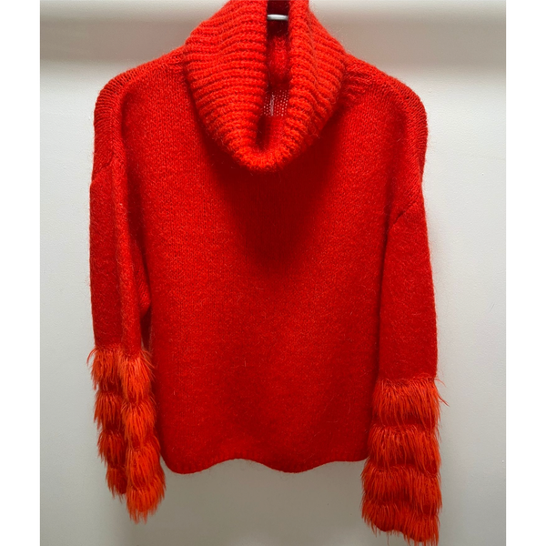 bright orange roll neck with four fluff design on sleeve