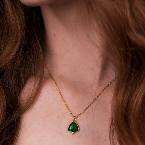Delicate triangle shape set faceted gemstone pendant on a fine gold plated chain. With the three tiny dots on the setting.