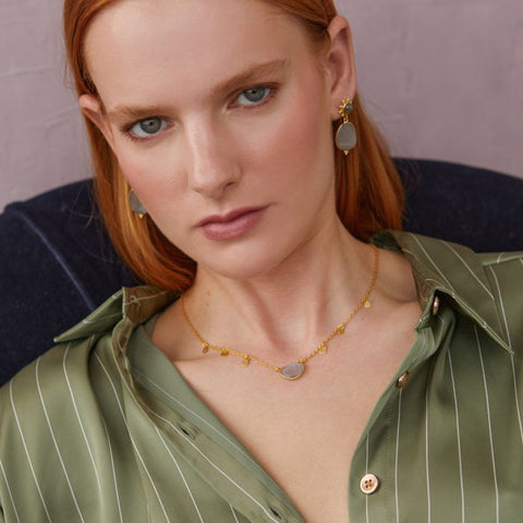 eaturing a faceted rounded triangle cut semi precious stone. The chain is adorned with tiny gold petals to give a delicate movement to this short pendant necklace. 