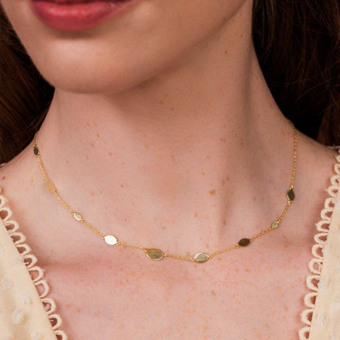 A beautifully versatile layering necklace inset with pressed coins, on a delicate gold chain. This short gold necklace is perfect to layer with any of our pendants for a truly unique stack. 