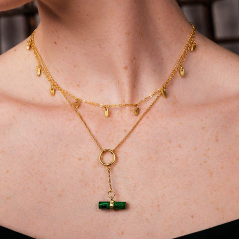 The Greta necklace features a hexagonal cut gemstone bar, held by a brushed gold loop. This delicate and minimalist pendant necklace lets the semi-precious stone be the star of the show.