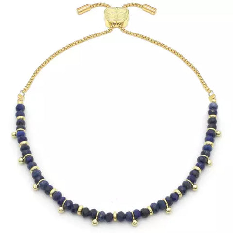 chic navy blue lapis lazuli gemstones. Known as the ‘Stone of truth and friendship’, lapis lazuli is said to bring love and harmony to relationships, protect from negative thoughts, alleviate pain, and promote wisdom and awareness.  It comes with an adjustable slider mechanism for comfort and adaptability, making it suitable for most wrists. Made with 12k plate on brass, length is up to 26cm