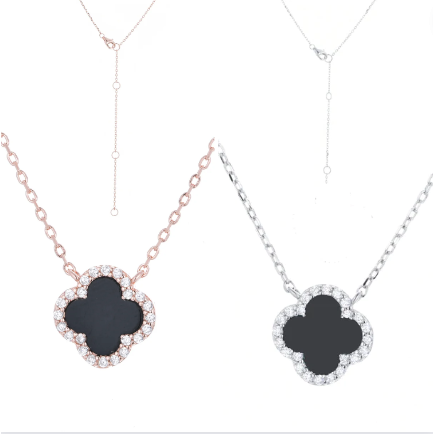 gold or silver chain and clover set with cubic zirconia around the edges and black onyx charm  