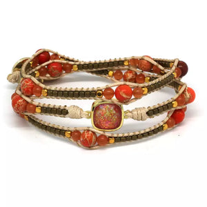 A gorgeous three-wrap waxed cord bracelet with gemstones of Cats-Eye and Hematite and Emperor Jasper stones with an orange opal effect crystal in the centre.