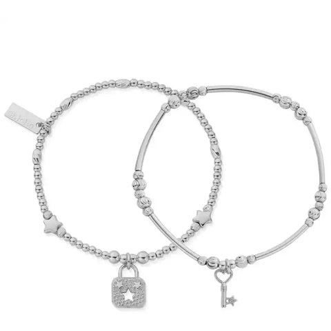 silver duo bracelets one with round beads and starswith a lock charm  the other with long straight bead with round bead intervals with s key charm 