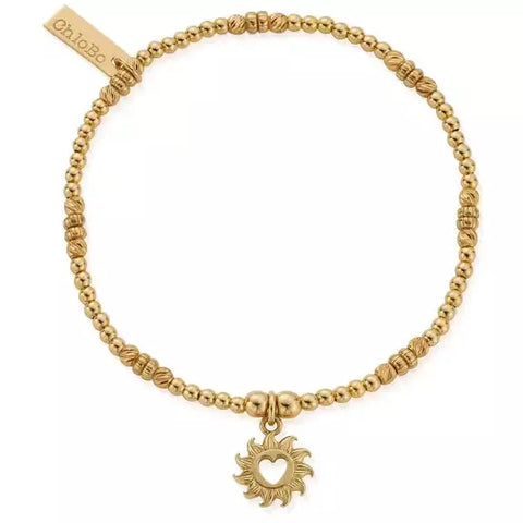 gold dainty bracelet with sun charm wiht open heart in centre